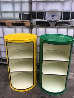 two yellow and green plastic storage containers sitting next to each other in front of pallets