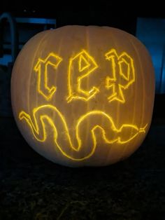 a carved pumpkin with the word eef on it's face in yellow light