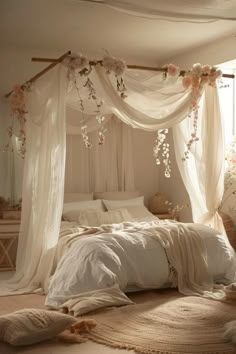 a bed with white linens and flowers on it