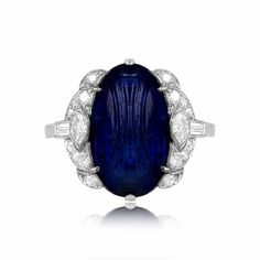 This superb Art Deco ring features a natural Burmese carved cabochon sapphire weighing approximately 8.64 carats. Accenting the center stone is an array of single-cut, marquise, and baguette-cut diamonds. This ring is antique and was handcrafted in the 1920s. The total approximate diamond weight is 0.60 carats. The measurements of the center sapphire are approximately 16.25mm x 9.25mm. The current finger size of this ring is 6 and it can be resized. If you have any questions about the Trowbridge Luxury Dazzling Sapphire Ring With Diamond Accents, Luxury Dazzling Sapphire Diamond Ring, Luxury Diamond Topaz Ring In Art Deco Style, Luxury Heirloom Sapphire And Diamond Ring, Luxury Dazzling Gemstones With Accents, Luxury Antique Cabochon Sapphire Ring, Formal Platinum Sapphire Cabochon Ring, Platinum Sapphire Cabochon Ring In Fine Jewelry Style, Fine Jewelry Platinum Sapphire Cabochon Ring