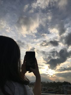 a woman taking a photo with her cell phone