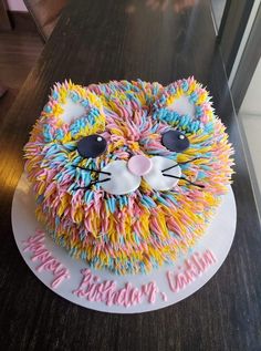 a birthday cake that looks like a cat with sprinkles on it