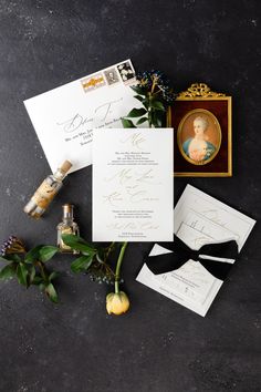 the wedding stationery is laid out on top of each other, including an envelope