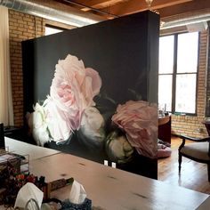 an office with large flowers painted on the wall