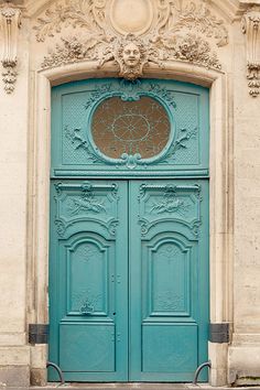 a blue door with ornate carvings on it