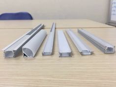 four different types of aluminum profiles on a table