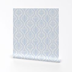 a blue and white wallpaper with an intricate design on it's side, against a white background