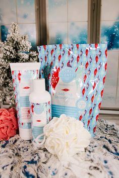 some items are sitting on a table next to a christmas tree and snowflakes