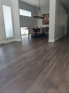 an empty living room with hard wood flooring