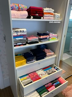 an organized closet with folded towels and other items