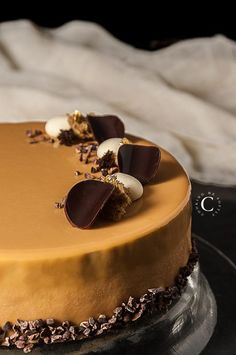 a chocolate cake with white and brown decorations