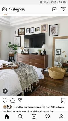 a bed room with a neatly made bed and a flat screen tv on the wall