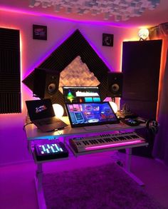 a laptop computer sitting on top of a desk in front of a sound board and speakers