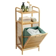 a bamboo shelf with towels and soaps on it