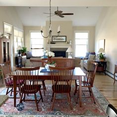 a dining room table and chairs with a rug on the floor in front of it