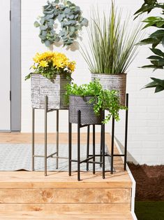 three planters sitting on top of a wooden step