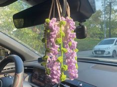 a car dashboard with flowers hanging from it's dash board