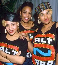 three women in black t - shirts and hats posing for the camera with their arms crossed