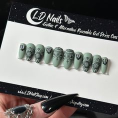 Welcome to LD Nails! 🖤 One set of 10 REUSABLE Press On Nails 🖤 🖤 Made to order in your shape & size 🖤 Sage Mandala: Pretty In Sage base with mandala designs and nail gems. Purchase INCLUDES an application kit! It consists of: 🖤 detailed application & removal instructions 🖤 a sealed and sanitary mani kit (100/180 file, buffer block, cuticle pusher) 🖤 2 alcohol pads 🖤 nail tabs or glue (glue is standard, request tabs in the personalization box if you prefer them!) *Only one kit is sent per order. Extra kits and kit contents can be picked up here 👉 https://www.etsy.com/ca/listing/817160463/application-kit-press-on-nails-gothic Est. 2020: LD Nails specializes in custom Gothic, Witchy and Alternative Press On Nails. I draw inspiration from what I love, so you’ll find heavy gothic influ Nails Gothic, Mandala Nails, Alcohol Pads, Nail Gems, Country Nails, Mandala Designs, Gel Press, Gem Nails, Cuticle Pusher