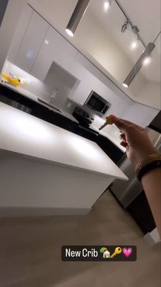 a person holding a knife in their hand near a kitchen counter with an oven and microwave