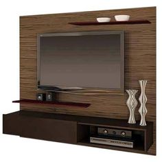 a flat screen tv mounted to the side of a wooden entertainment center with two shelves