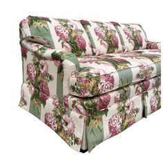 an upholstered couch with pink flowers and green trimmings on the back