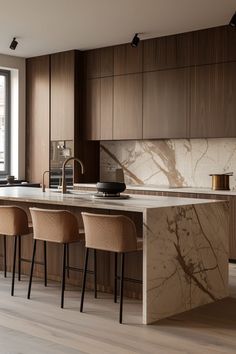 a kitchen with wooden cabinets and marble counter tops, along with bar stools that match the flooring