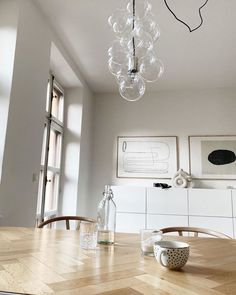 a dining room table that has some glasses on it