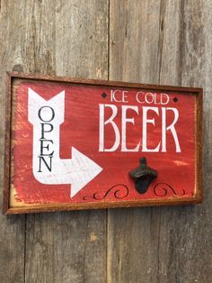 a wooden sign that says ice cold beer and an arrow pointing up to the right