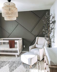 an image of a baby's room with grey walls and white cribs