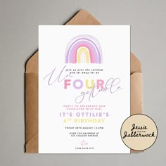 a birthday card with a rainbow design on the front, and a brown envelope underneath it