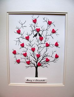 a paper cut tree with red hearts on it