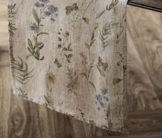 a close up of a cloth hanging on a clothes line with wood flooring in the background