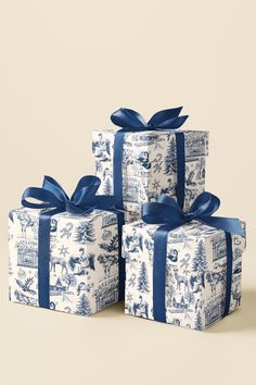 three wrapped presents with blue ribbon and bows