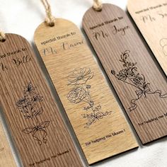 four wooden tags with floral designs on them