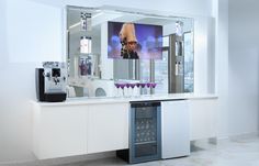 a bathroom with a sink, mirror and wine glasses on the counter in front of it