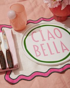 there is a place mat with the name ciao bella and utensils on it