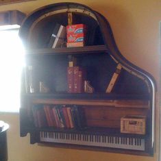 a piano shelf with books and other items on it