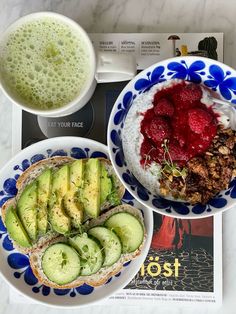 there are two plates with food on them next to a cup of coffee and a book