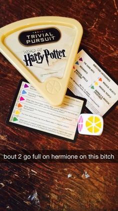 an image of a harry potter game on a table with some pieces of paper next to it