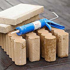 a bunch of cement blocks with a blue blower on top of them and some other items