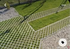 an aerial view of a grassy area with gravel and grass in the center, surrounded by metal grates