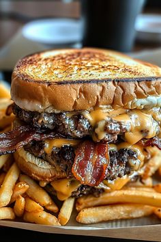 a bacon cheeseburger with fries on the side