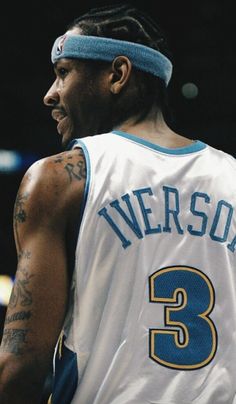 a close up of a basketball player with tattoos on his arm and headbands