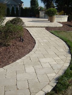 a brick walkway in front of a house