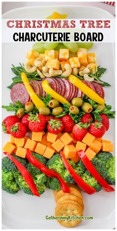 christmas tree charcuterie board with broccoli, strawberries, peppers and cheese