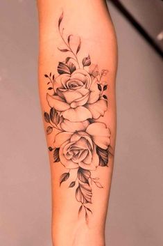 a black and white rose tattoo on the leg