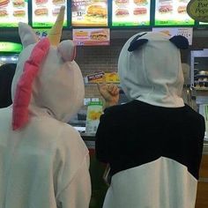 two people in costumes are ordering food at a fast food restaurant