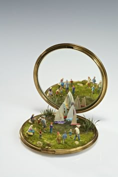 an open box with miniature people in it