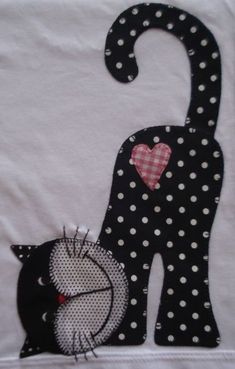 a black cat with white polka dots and a pink heart on it's back